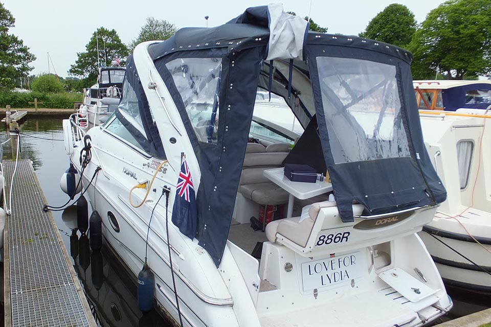 Photograph of the Love for Lydia alongside a marina after the accident showing the canopy as found