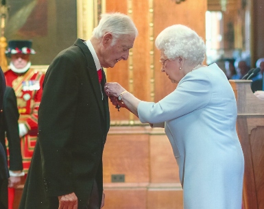 Norman Finlay MBE receiving his award from Her Majesty The Queen in 2018