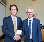 James Harrison (left) receiving his Award from Sir Alan
